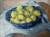A painting by Christopher Wood depicting more then a dozen lemons sat in a blue wicker basket