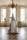 A sculpture of a woman with tentacle-like limbs cradling a limp boy stands on a plinth in the centre of a room.