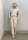 A soft sculpture of a cowboy dressed entirely in white, wearing a hat and sunglasses, slouched against a wall with his hands in his pocket.