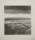 A monochrome etching by Norman Ackroyd depicting a flat river bank scored by water channels leading to a calm river with a few moored boats at the river edge