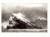 A monochrome etching by Norman Ackroyd depicting a craggy island rising from the sea and the sky filled with seabirds