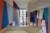 A colourful geometric mural on the walls on a contemporary stone staircase in an art gallery.
