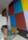 A colourful geometric mural on the walls on a contemporary stone staircase in an art gallery.