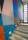A colourful geometric mural on the walls on a contemporary stone staircase in an art gallery.