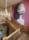 A huge Greek urn printed on wallpaper hanging over a grand wooden staircase.