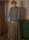 A painting by British painter Harold Gilman showing a woman in a smock standing demurely in the corner of a room, looking down at her hands.