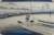 A man stands at the prow of a boat