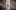 Sculpture of a young girl with closed eyes standing on tiptoes in the middle of a period home hallway.