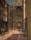 Painting by Walter Sickert showing a street ending at the doors of a magnificent church with stained glass window.