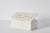 A plaster sculpture by Des Hughes in the form of a box with two simple line figures lie intertwined on the lid of the box.