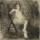 A nude woman sitting on a folding chair, her right arm resting on the back of her chair and left leg crossed over the right.