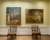 Interior of a Queen Anne townhouse with two landscape paintings of the Australian outback painted by Sidney Nolan hanging behind two period chairs.