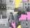A collage of black and white images of building fronts and two women wearing copats with their back to the viewer interspered with block of pink and yellow.