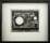 Abstract black and white print with circles of various sizes stacked on top of squares.