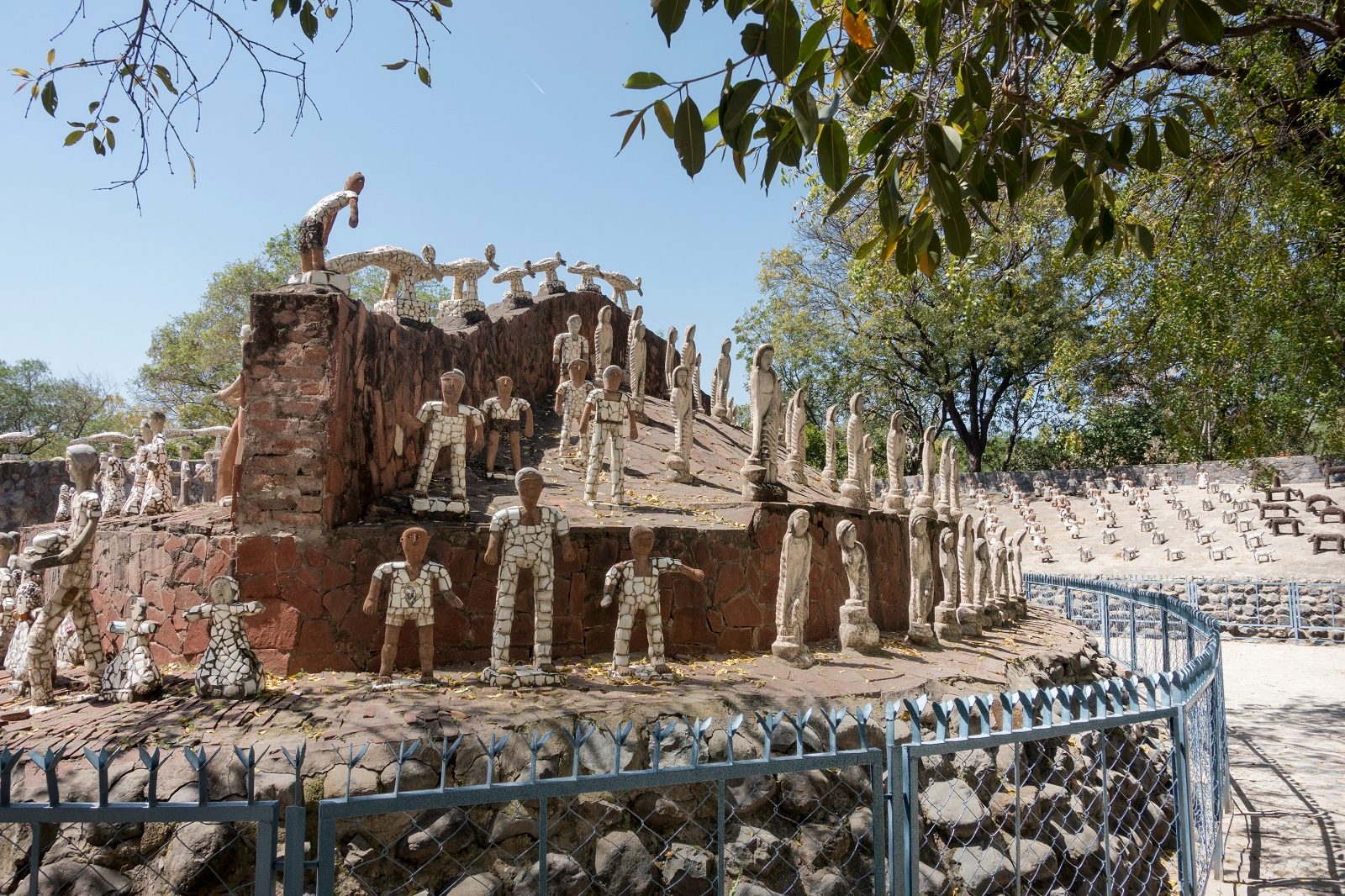 Rows of sculptures of human figures made out of discarded pottery