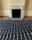A black and white carpet in geometric shapes lying in front of a white fireplace