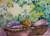 A ginger cat lies in a basket lined with a purple blanket. Leaves cover the background, suggesting the cat is in the garden