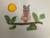 Collage of an owl with a floral patterned body sitting a tree branch made from string and green leaves. On the left side is an orange and yellow sun.