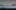 Pixelated photograph of a harbour with a sailing boat to bottom left and shore to right