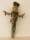 A cross shaped doll make from string.