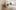 Floral clay sculptures in a large white room with period features including cornicing and a marble fireplace