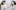 Two women face each other. Their arms extend to touch the other's face with a paint brush. Their expressions are neutral and their heads are turned toward the the viewer.